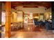 Open-concept living room featuring wood beams, dining area, and modern kitchen at 75 Rivercreek Xing, Kingston, GA 30145