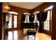 Sophisticated living room with a fireplace, wood paneling, piano, large windows, and elegant décor at 75 Rivercreek Xing, Kingston, GA 30145