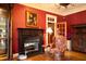 Detailed shot of a living room fireplace with wood mantel, surrounded by antique furnishings and warm lighting at 75 Rivercreek Xing, Kingston, GA 30145