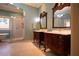 Main bathroom featuring double vanities, glass shower, and a soaking tub at 75 Rivercreek Xing, Kingston, GA 30145