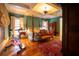 Well-appointed main bedroom with hardwood floors and coffered ceiling featuring a sitting area and exercise bike at 75 Rivercreek Xing, Kingston, GA 30145