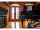 Music room with grand piano, hardwood floors, and fireplace at 75 Rivercreek Xing, Kingston, GA 30145