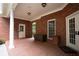Brick-walled patio with access to the exterior, offering a private outdoor living space with classic architectural details at 75 Rivercreek Xing, Kingston, GA 30145