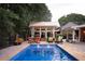 Backyard features an in-ground pool with a gazebo and outdoor seating, creating an ideal outdoor living space at 75 Rivercreek Xing, Kingston, GA 30145