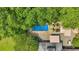 Aerial view of a backyard pool surrounded by lush greenery and an outdoor living space at 75 Rivercreek Xing, Kingston, GA 30145