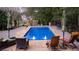 Rectangular pool with patio furniture, umbrellas, and safety cover at 75 Rivercreek Xing, Kingston, GA 30145