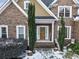 Front entrance with wooden door and landscaping at 7801 Windswept Way, Douglasville, GA 30135