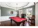Game room features a pool table, chandelier, and hardwood floors at 928 Buckhorn Bnd, Locust Grove, GA 30248