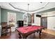 Spacious game room with pool table and access to the entryway at 928 Buckhorn Bnd, Locust Grove, GA 30248