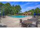 Relaxing pool area with lounge chairs and tables at 928 Buckhorn Bnd, Locust Grove, GA 30248