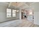 Open dining room with coffered ceiling and kitchen views at 115 Felicity Pike, Locust Grove, GA 30248