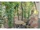 Private balcony with bistro table and chairs, overlooking wooded area at 2438 2Nd Nw St, Atlanta, GA 30318