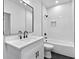 Clean bathroom with white vanity, black faucets, and a white bathtub at 2438 2Nd Nw St, Atlanta, GA 30318