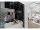 Spa-like bathroom with soaking tub and black tile feature wall at 2438 2Nd Nw St, Atlanta, GA 30318