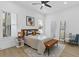 Bright bedroom with a king-size bed, wood accents, and a ceiling fan at 2438 2Nd Nw St, Atlanta, GA 30318