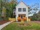 Two-story modern farmhouse with wood accents and a landscaped lawn at 2438 2Nd Nw St, Atlanta, GA 30318