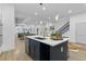 Open concept kitchen with large island and breakfast bar, and a view into the living room at 2438 2Nd Nw St, Atlanta, GA 30318