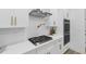 Modern kitchen detail with gas cooktop and white subway tile backsplash at 2438 2Nd Nw St, Atlanta, GA 30318