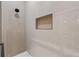 Clean shower with light beige tile and wood shelving at 2438 2Nd Nw St, Atlanta, GA 30318