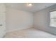 Well-lit bedroom with carpet and neutral walls at 328 Shine Dr, Stockbridge, GA 30281