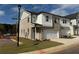 Two-story townhome with brick and siding, two-car garage, and landscaping at 328 Shine Dr, Stockbridge, GA 30281