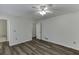 Well-lit bedroom with wood-look floors and access to bathroom at 1530 Plunketts Rd, Buford, GA 30519