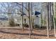 House nestled among trees with a large yard at 1530 Plunketts Rd, Buford, GA 30519