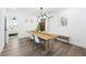 Bright dining room features a large wooden table, modern light fixture, and hardwood floors at 2851 Long Way, Decatur, GA 30032