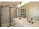 Bathroom with double vanity, large mirror, and walk-in shower at 2920 Ilir Nw Mnr, Atlanta, GA 30318