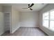 Well-lit bedroom with ceiling fan, window, and walk-in closet at 2920 Ilir Nw Mnr, Atlanta, GA 30318