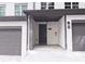 Townhome's front entrance with gray door and covered porch at 2920 Ilir Nw Mnr, Atlanta, GA 30318