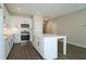 Open kitchen with white cabinets, large island, and stainless steel appliances at 2920 Ilir Nw Mnr, Atlanta, GA 30318