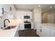 Modern kitchen featuring white cabinets, stainless steel appliances, and quartz countertops at 2920 Ilir Nw Mnr, Atlanta, GA 30318