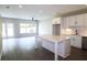 Open kitchen with white cabinets, large island, and stainless steel appliances at 2920 Ilir Nw Mnr, Atlanta, GA 30318