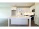 Open kitchen with white cabinets, large island, and stainless steel appliances at 2920 Ilir Nw Mnr, Atlanta, GA 30318