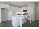 Open kitchen with white cabinets, large island, and stainless steel appliances at 2920 Ilir Nw Mnr, Atlanta, GA 30318