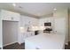 Open kitchen with white cabinets, large island, and stainless steel appliances at 2920 Ilir Nw Mnr, Atlanta, GA 30318