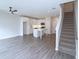 Open living room with hardwood floors, kitchen, and staircase views at 2920 Ilir Nw Mnr, Atlanta, GA 30318