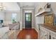 Bright entryway with hardwood floors, dark front door, and decorative shelving at 3280 Buffington Ln, Cumming, GA 30040