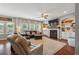 Spacious living room with hardwood floors, fireplace, built-in shelving and large windows at 3280 Buffington Ln, Cumming, GA 30040