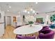 Modern dining area with an oval table and purple chairs at 401 Brooch Way, Stockbridge, GA 30281