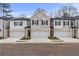 Two-story townhome with white and gray siding, two-car garage, and landscaping at 401 Brooch Way, Stockbridge, GA 30281