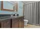 Bathroom with dark wood vanity, granite countertop, and shower/tub combo at 105 Jefferson Ne Cir, Atlanta, GA 30328