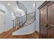 Grand curved staircase with wrought iron railing, elegant entryway at 105 Jefferson Ne Cir, Atlanta, GA 30328