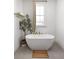 Relaxing bathroom with freestanding soaking tub and neutral color palette at 1870 Vigo Ne St, Atlanta, GA 30307