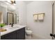 Small bathroom with dark vanity, white countertop, and frameless shower at 1870 Vigo Ne St, Atlanta, GA 30307