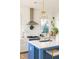 Bright kitchen features white cabinets, a blue island, and a farmhouse sink at 1870 Vigo Ne St, Atlanta, GA 30307