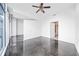 Bright bedroom with modern gray floor, fan, and large windows at 250 Pharr Ne Rd # 716, Atlanta, GA 30305