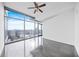 Bright bedroom with modern gray floor, and a large window offering stunning city views at 250 Pharr Ne Rd # 716, Atlanta, GA 30305