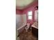 Small bathroom with pink walls, tub, and toilet at 416 Culloden Moor Dr, Mcdonough, GA 30253